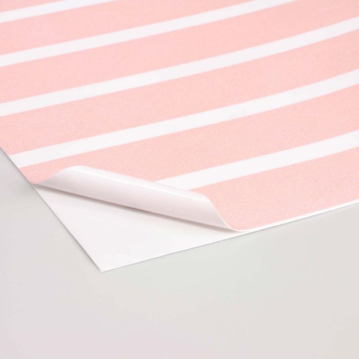 Das Bild zeigt einen Ausschnitt eines bedruckten Aufkleber-Materials (weiße Klebefolie).