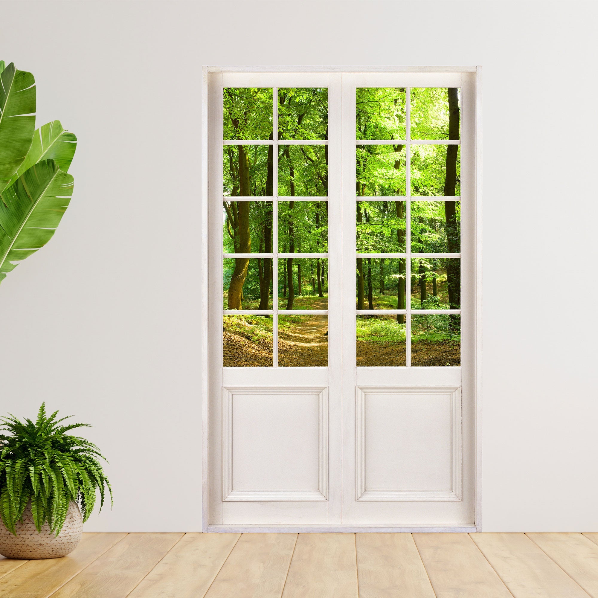 200cm großer Aufkleber für Wand und Möbel in Form einer Terrassentür mit dem Durchblick auf einen Wald. Als Beispiel an einer Wand neben Zimmerpflanzen verklebt.