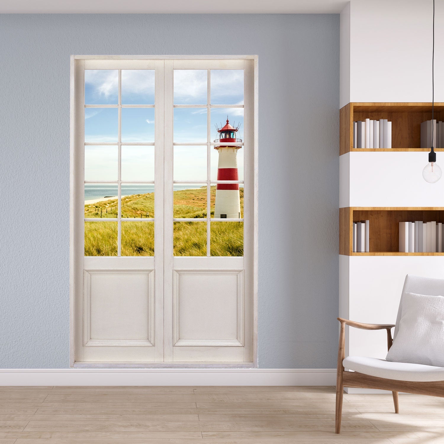 Leseecke zum entspannen m mit einem Terrassentür Aufkleber mit Sprossenfenster und Blick auf einen traumhaften Leuchtturm in den Dünen der Ostsee. An einer grauen Wand verklebt neben einer Leseecke.