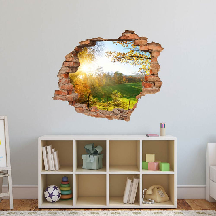 Wandtattoo - Wanddurchbruch Aufkleber "Waldlichtung" im Kinderzimmer an einer hellblauen Wand über einem Sideboard verklebt.