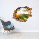 Wandtattoo - Wanddurchbruch Aufkleber "Waldlichtung" an der Wand über einem grauen Sessel.