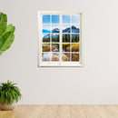 Wandtattoo bedruckt mit Fensterrahmen und tollem Naturbild von Bergsee und schneebedeckten Bergen. An einer weissen Wand, neben zwei Zimmerpflanzen und Holzboden.