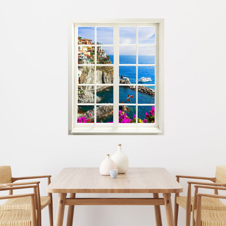 Wandaufkleber Sprossenfenster mit toller Aussicht auf ein Dorf in Italien Cinque Terre. Vergrößert Zimmer optisch. Hier über einem Esstisch.