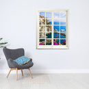 Selbstklebendes Wandaufkleber-Bild für Flur und Wohnzimmer oder Schlafzimmer. Hier ein Fensteraufkleber mit dem Motiv Cinque Terra an einer weissen Wand über einem grauen Sessel.