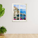 Hingucker für dunkle Räume oder ohne Fenster, selbstklebendes Wandtattoo als gedruckter Fensterrahmen mit tollem Ausblick auf ein buntes Dorf "Cinque Terre" an einer weissen Wand neben Zimmerpflanzen.