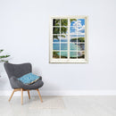 Wandtattoo Motiv Fensterblick geschlossen "Meer und Bucht" in hellem Raum neben grauem Sessel.