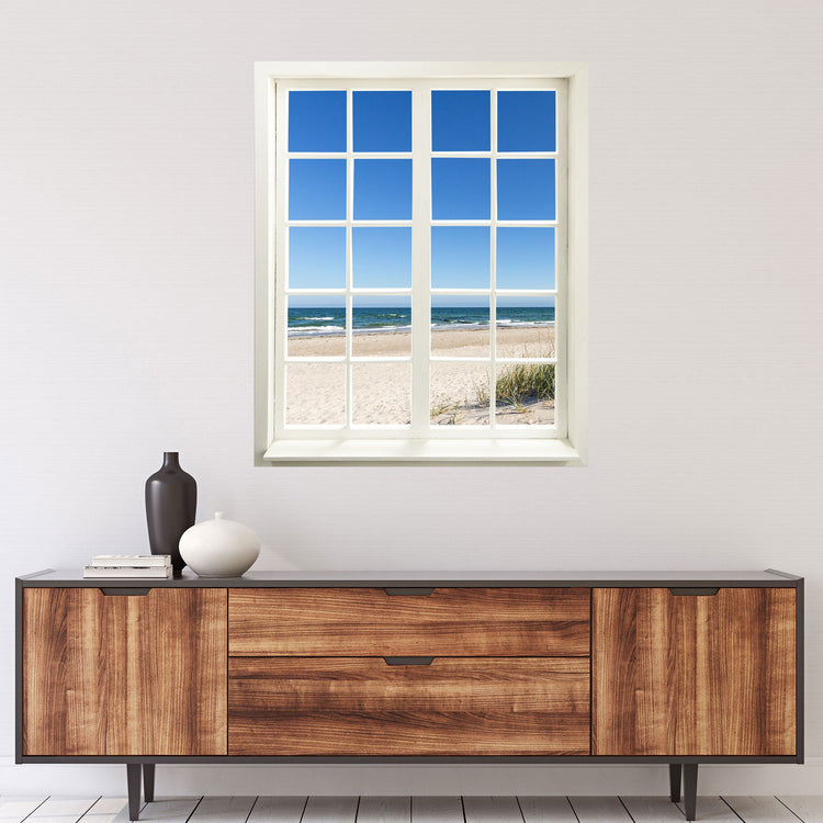 Selbstklebende Wandtapete in Form eines geschlossenen Fensters am Meer - Landschafts-Fotografie. Motiv: Ostsee Strand über einer Kommode an der Wand.