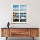 Wandaufkleber Fensterblick geschlossen, selbstklebend mit erholsamer Aussicht auf ein Seeufer in Schweden. Hier an einer weissen Wand über einer Kommode aus Holz.