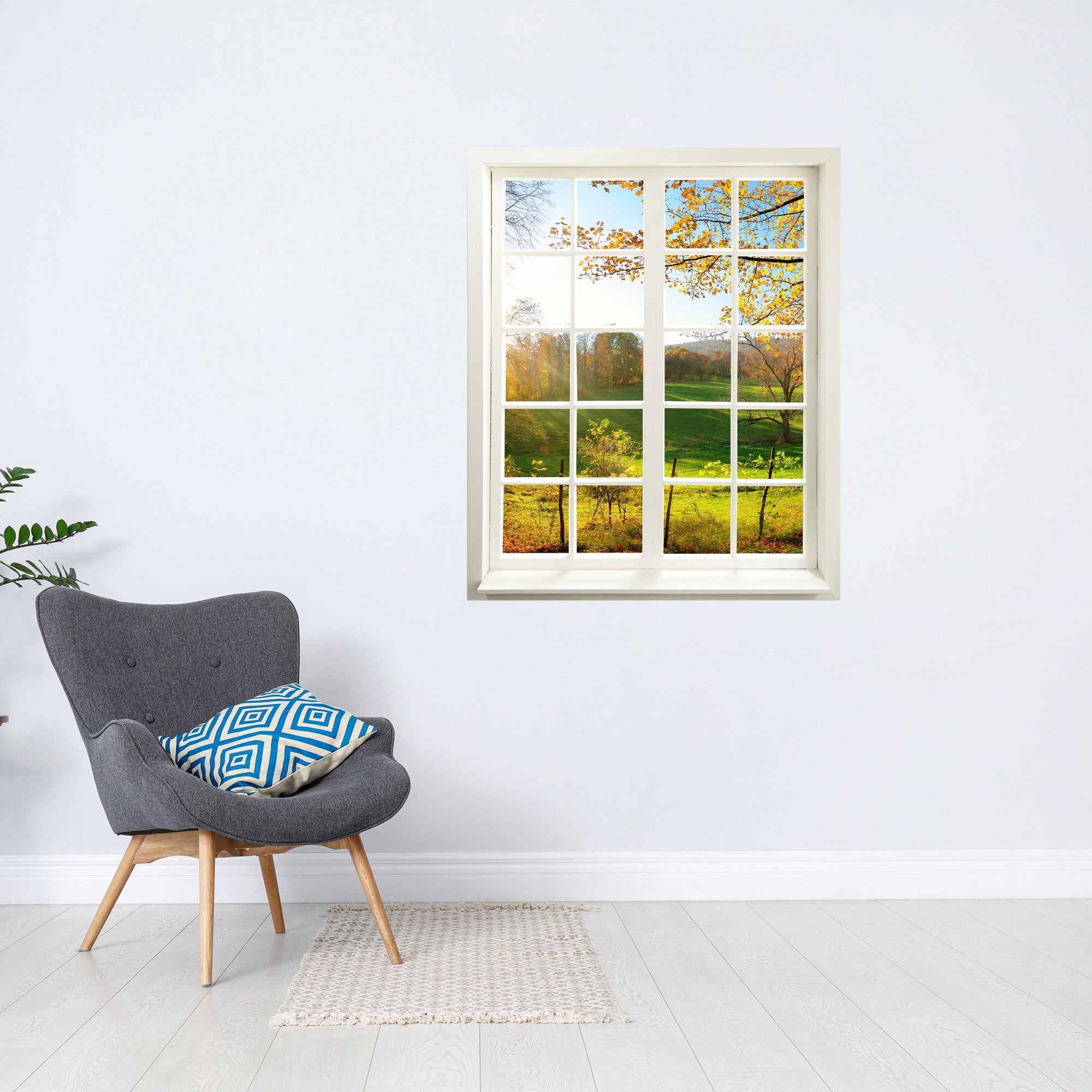 Tolles Wandbild für dunkle und kleine Räume, gedrucktes Fensterblick mit dem Motiv "Waldlichtung" mit Sonnenschein. An der Wand über einem grauen Sessel.