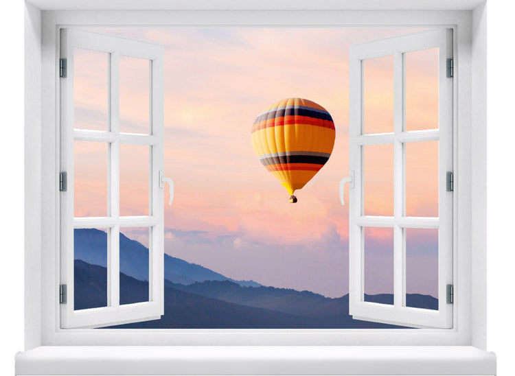 Wandaufkleber mit dem Motiv offenes Fenster mit Blick auf einen Heißluftballon im Sonnenuntergang über einer Berglandschaft – dekoratives 3D-Fensterbild mit Panorama-Effekt.