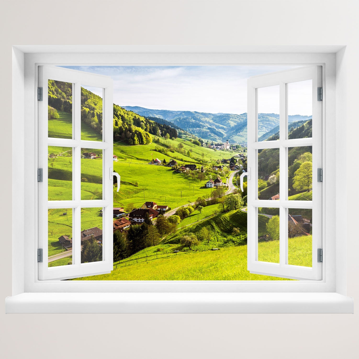 Offenes Fenster mit Ausblick auf grüne Hügel, ein idyllisches Dorf und bewaldete Berge – dekoratives Fensterbild mit realistischer 3D-Optik für naturnahes Wohnambiente. An einer weissen Wand verklebt.