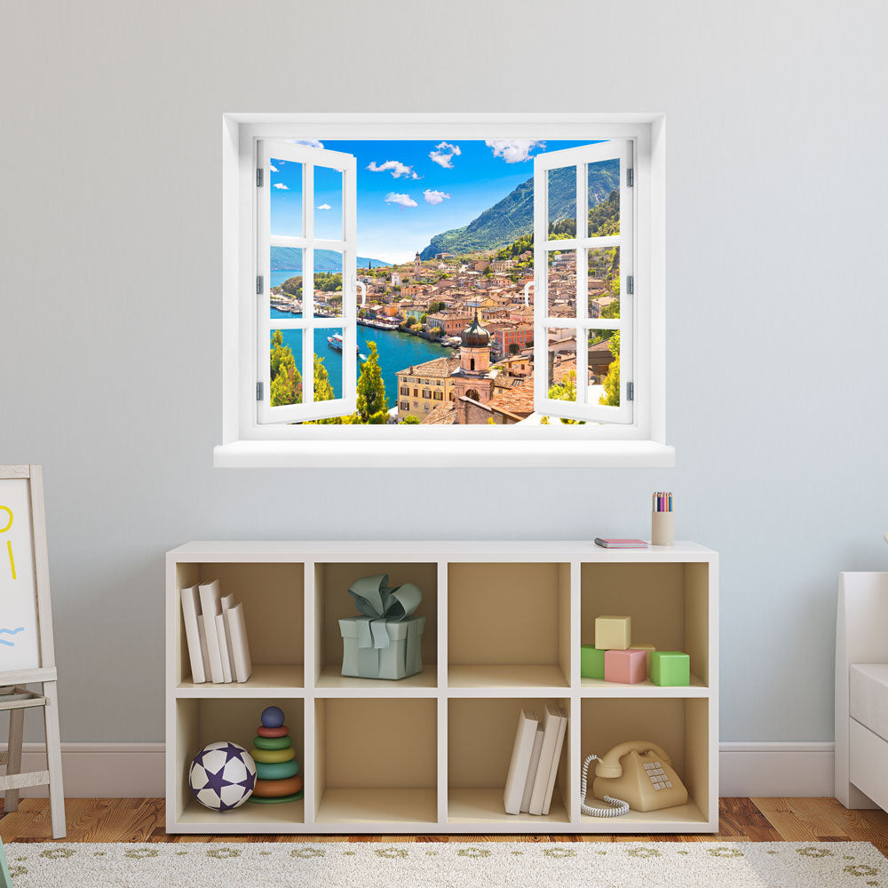 Wandsticker offenes Fenster "Dorf am See" über Spielzeugregal im Kinderzimmer.