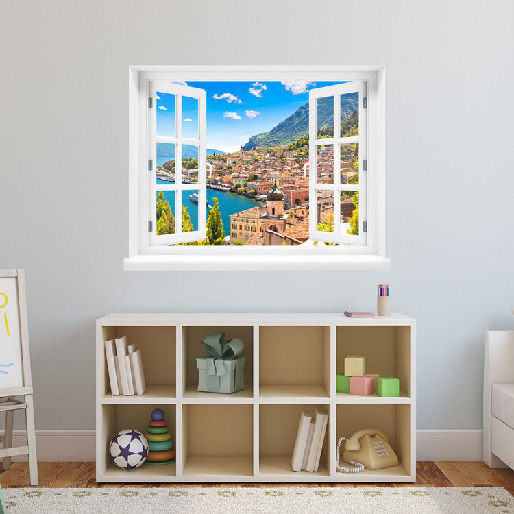 Wandsticker offenes Fenster "Dorf am See" über Spielzeugregal im Kinderzimmer.
