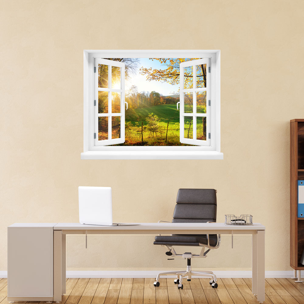 Wandaufkleber offenes Fenster "Wald mit Lichtung" am Arbeitsplatz an einer gelben Wand.