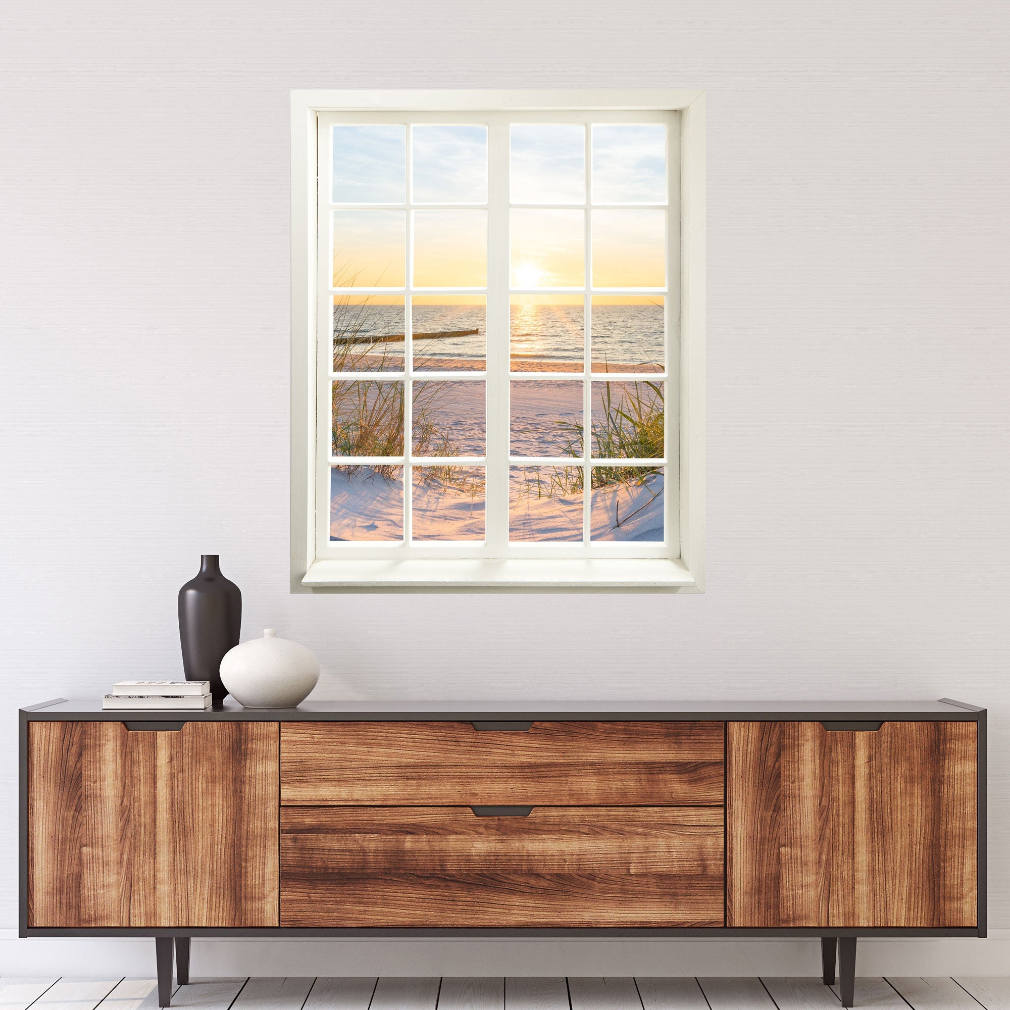 Selbstklebende Wandtapete in Form eines Fensters mit Sonnenuntergang am Meer Landschafts-Fotografie. Motiv: Dünen und Meer über einer Kommode an der Wand.