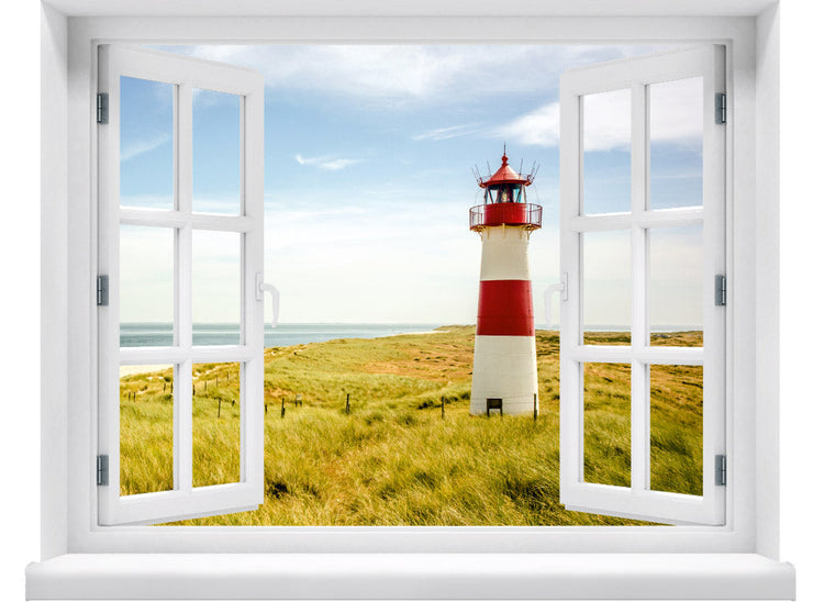 Großansicht eines Wandaufklebers: offenes Fenster mit Blick auf rot-weißen Leuchtturm inmitten von Dünenlandschaft an der Küste unter blauem Himmel – maritimes Küstenmotiv mit Nordsee- oder Ostsee-Flair.