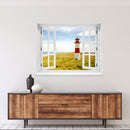 Großansicht eines Wandaufklebers: offenes Fenster mit Blick auf rot-weißen Leuchtturm inmitten von Dünenlandschaft an der Küste unter blauem Himmel – maritimes Küstenmotiv mit Nordsee- oder Ostsee-Flair. Als Einrichtungsbeispiel an einer weissen Wand, über einem Holz-Sideboard verklebt.
