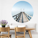 Großansicht eines runden Wandaufklebers mit einem Motiv vom Steg in der Nordsee. Das Bild schafft einen 3D Effekt und sorgt für eine Tiefe. Als Dekoidee ist es an einer weissen Wand verklebt über einer Essecke.