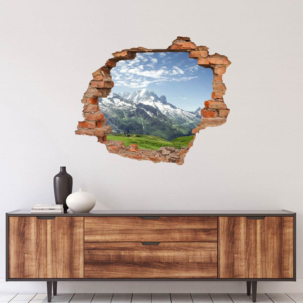 Wandtattoo Ziegelsteinwand Aufkleber  "Almwiese und Berge" über einem Sideboard.