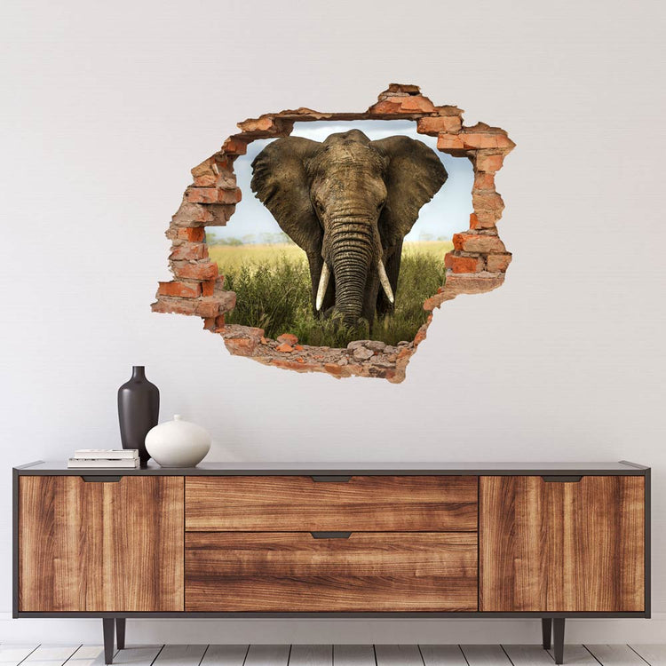Wandtattoo Mauerdurchbruch "Elefant" über holz-farbigem Sideboard verklebt.