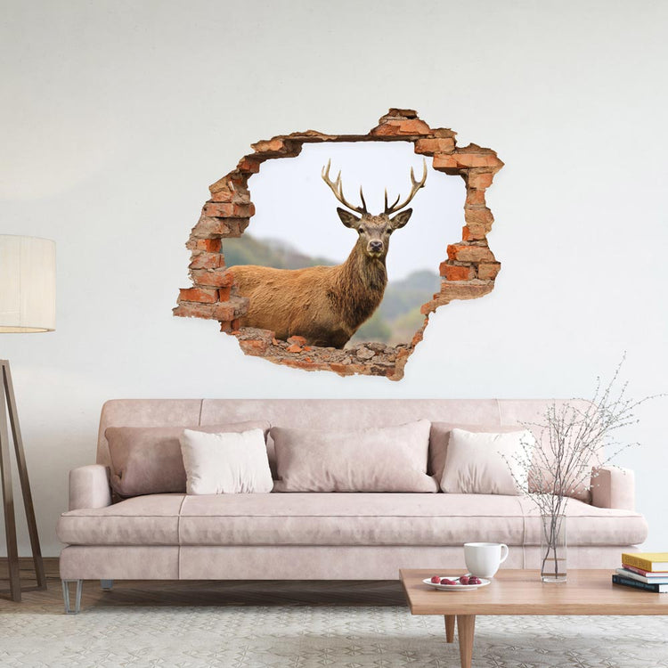 Wandtattoo Mauerdurchbruch "Hirsch" im Wohnzimmer über einem  rosafarbenem Sofa.