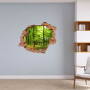 Wandaufkleber - Wanddurchbruch "Wald" mit Bücherwand und einem Stuhl, an einer hellblauen Wand verklebt.