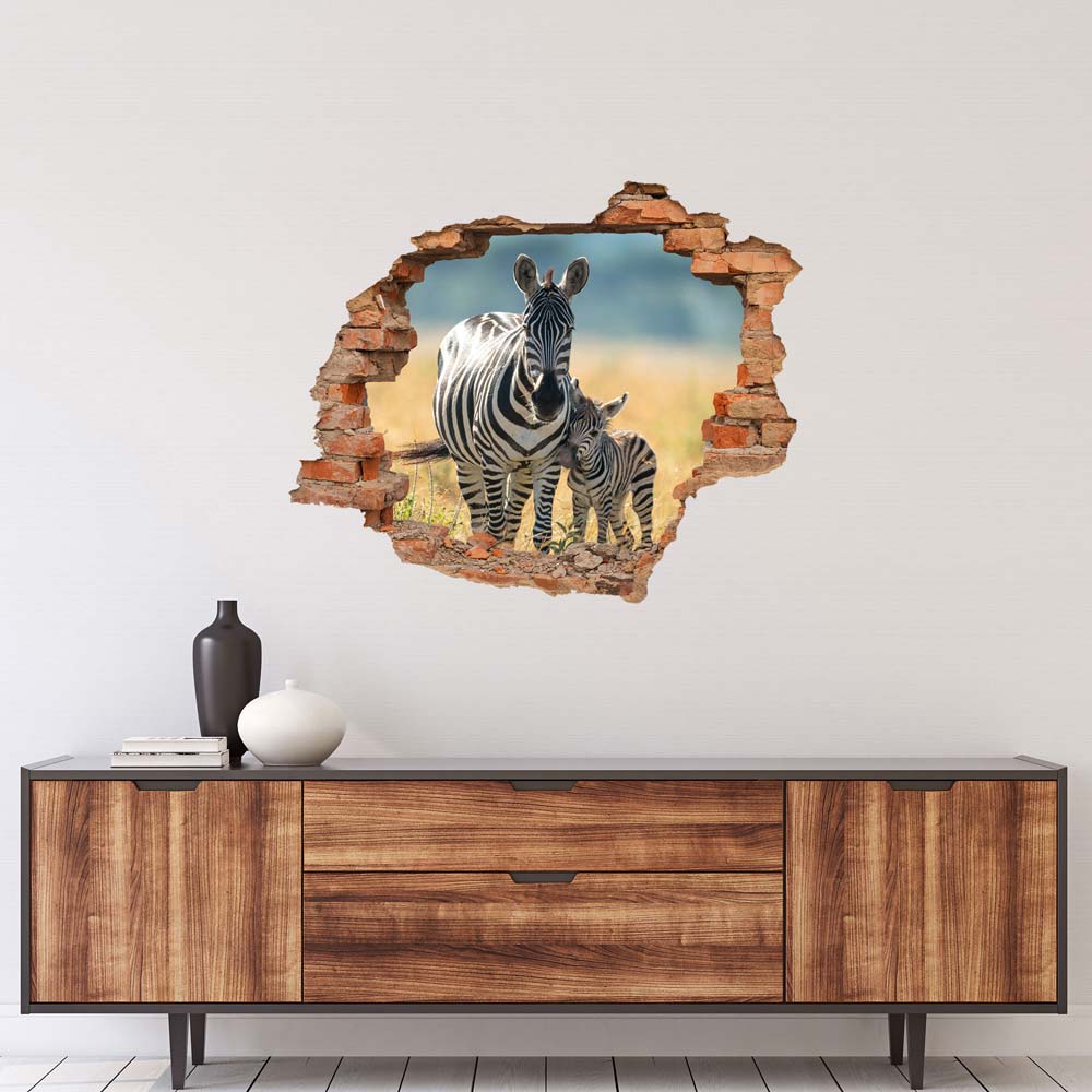 Wandtattoo - Wanddurchbruch "Zebra mit Fohlen" über braunem Sideboard an der Wand verklebt.